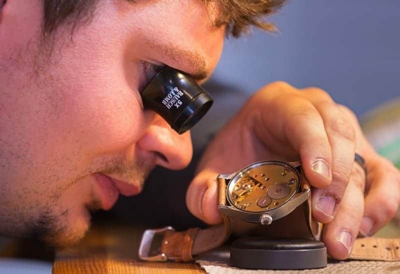 justin inspecting and repairing a watch at the watchmaker's shop