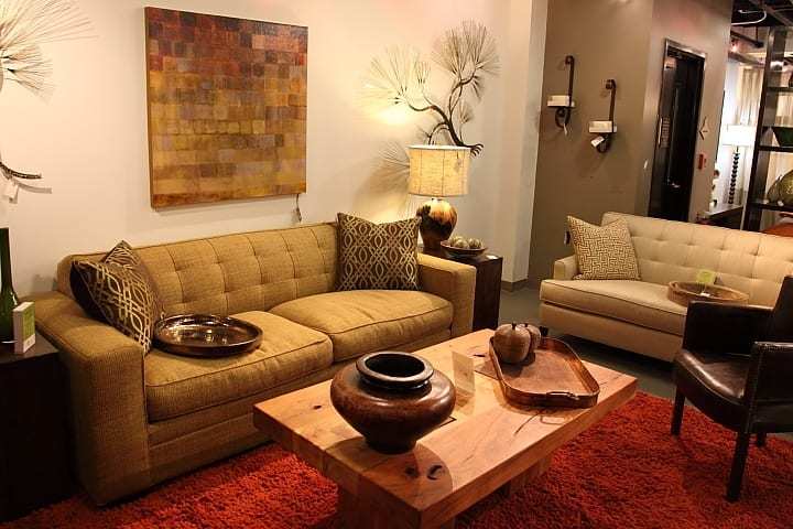 a shot of two beige couches and a coffee table in four corners home