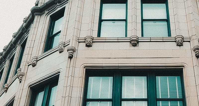 an exterior shot of the some of the grotesque faces lining the walls of Grove Arcade