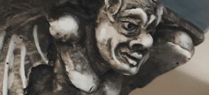 an up close shot of a gargoyle lining the hallways of the interior Grove Arcade