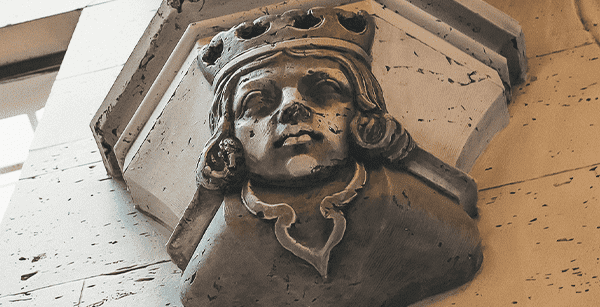 a grotesque faces of a king on the inside of the Grove Arcade