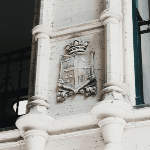 a medieval style shield carved into the stone of an interior column of the grove arcade