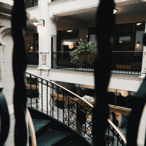picture taken through the iron bars on the second floor looking over the staircase and looking across to the other side