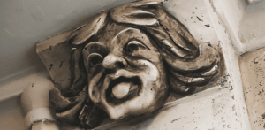 an up close photo of a grotesque face that has its tongue sticking out