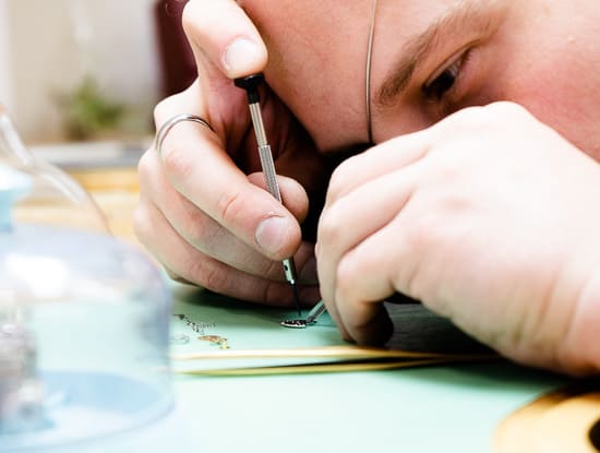 closely repairing a watch