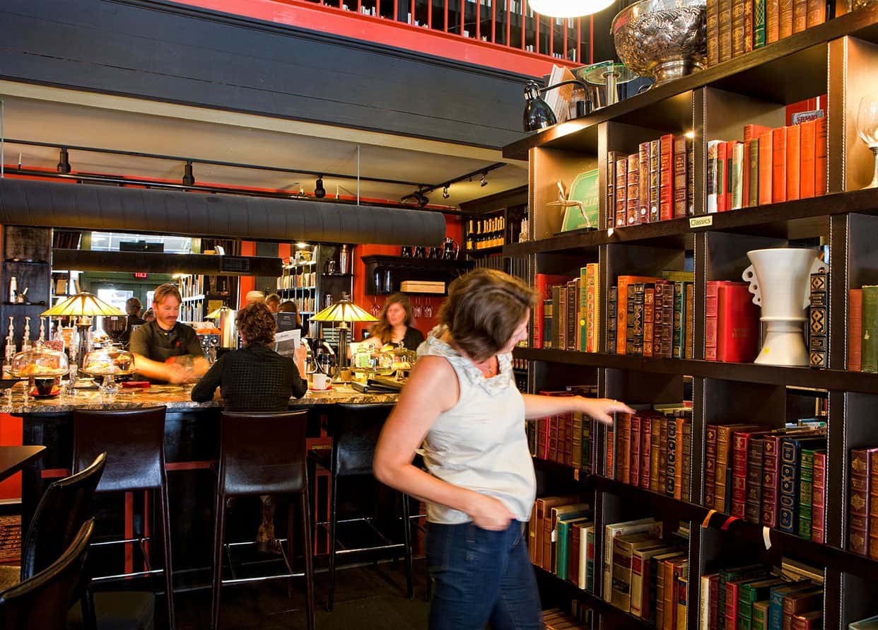 woman browsing books at a wine bar