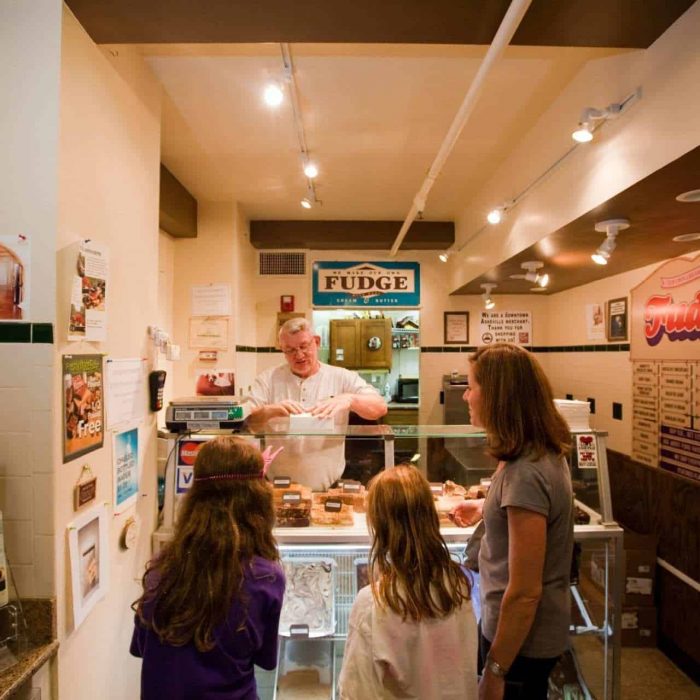 a woman and two girls buying fudge from the owner of Nutz About Fudge